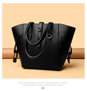 Close-up of black litchi pattern leather tote bag with silver metal hardware detail