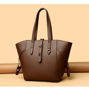 Detail view of large dark brown tote bag with premium lychee grain leather texture