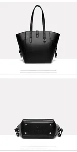 Detail view of the black tote bag showing the back and the studded base with logo