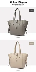 Detail view of large tote bags in grey and beige pebble leather with metal buckle