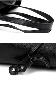 Close-up of litchi grain leather tote bag handles and adjustable drawstring closure
