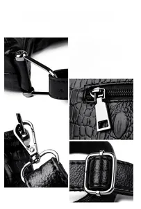Detail of durable gunmetal hardware and glossy crocodile texture on the black bucket bag