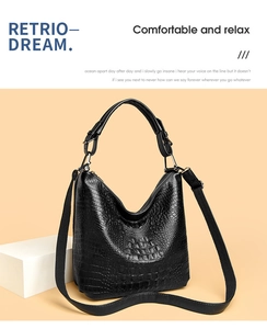 Detailed macro view of black crocodile pattern leather bag with silver metal hardware