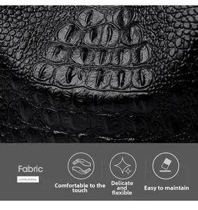 Close-up of black crocodile pattern fabric showing detailed texture and soft material