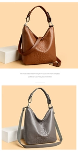 Detail view of crocodile embossed leather tote bags in brown and grey with gunmetal hardware