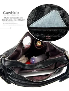Detailed interior of crocodile pattern leather bucket bag showing multi-compartment structure