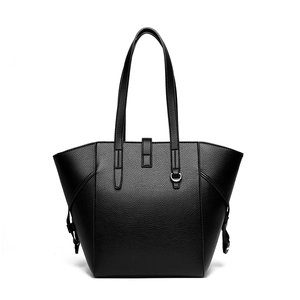 Minimalist black lychee texture tote bag with metal ring and shoulder strap on white backdrop