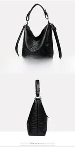Detail of black faux crocodile leather bucket bag with top handle and shoulder strap