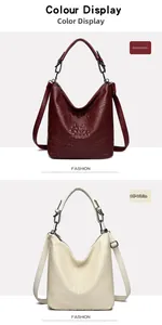 Vertical display of burgundy and off-white crocodile pattern hobo bags with metallic hardware
