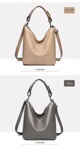 Detail of khaki and gray crocodile embossed hobo bags with adjustable shoulder straps