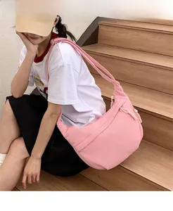 Detail of pink corduroy shoulder bag with soft textured fabric and drawstring accents