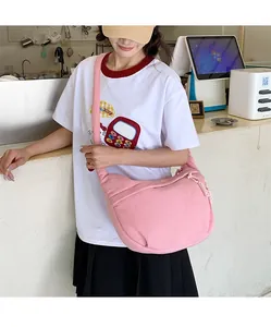 Pink corduroy crossbody dumpling bag showing large capacity and soft textured fabric detail