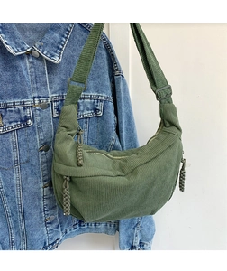 Detail view of olive green corduroy crescent crossbody bag with adjustable strap and metal zipper