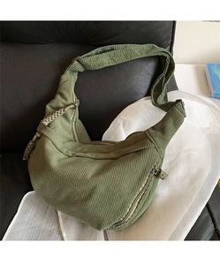 Detail of army green corduroy crescent bag showing fabric texture and braided zipper pull