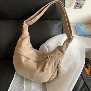 Corduroy beige crossbody half-moon bag with textured finish and woven zipper puller