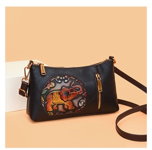 Close-up of black crossbody bag with ethnic elephant embossment and high-quality zipper
