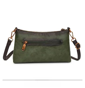 Detail view of the vintage green gradient crossbody bag with a metal rear zipper pocket