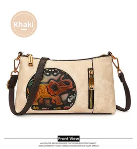 Close-up of khaki leather shoulder bag with colorful embossed elephant and gold hardware