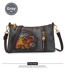 Close-up of vintage grey crossbody bag featuring a detailed embossed elephant design