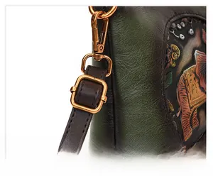 Detail of adjustable leather strap with vintage bronze buckle on embossed elephant bag