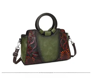 Close-up of retro floral embossed tote with round wooden handle and brown strap