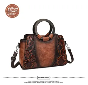 Detail view of sunflower embossed pattern on yellow-brown vintage handbag for women