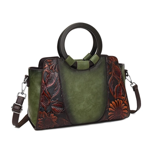 Olive green floral embossed handbag with round wooden handles and long strap