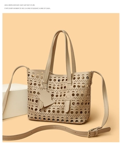 Detail of laser-cut geometric patterns and cat charm on beige hollow-out tote bag