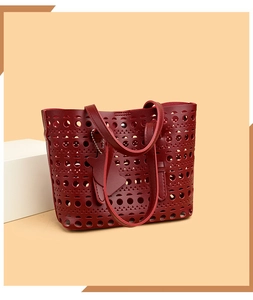 Macro detail of wine red hollowed-out tote bag with geometric laser-cut patterns