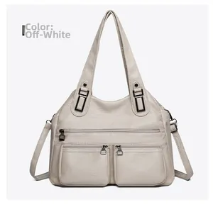 Détail du sac fourre-tout beige avec texture grainée et doubles poches zippées avant