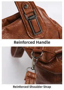 Détails des poignées renforcées et coutures de bandoulière sur sac en cuir marron