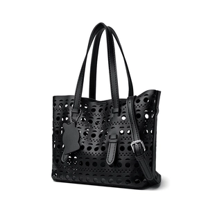 Hollow out black tote bucket bag with geometric patterns and cat charm accessory