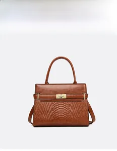 Detailed front view of dark brown tote bag with crocodile pattern and golden metal lock
