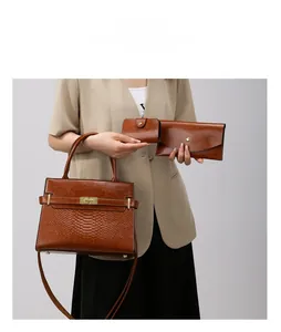 Three-piece brown crocodile embossed faux leather bag set with gold hardware details