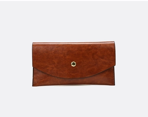 Detailed macro view of vintage brown embossed leather wallet with golden round metal snap button