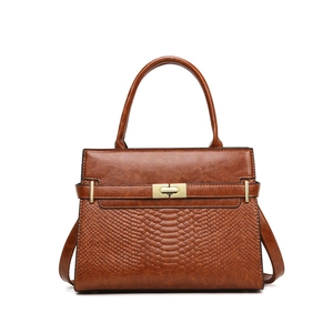 Brown vintage handbag with snake pattern embossing and elegant gold twist lock closure