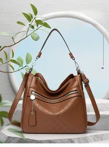 Macro shot of brown pebble grain leather handbag with diamond quilted texture detail