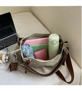 Detail view of khaki canvas tote bag interior showing large capacity for laptop and daily items