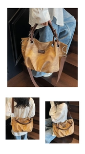 Retro brown oversized tote bag with metal eyelets and adjustable shoulder straps