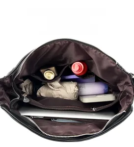 Internal view of the large black faux leather tote bag showing organized compartments