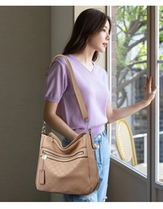 Detail of khaki soft leather crossbody bag with lychee texture and diamond pattern