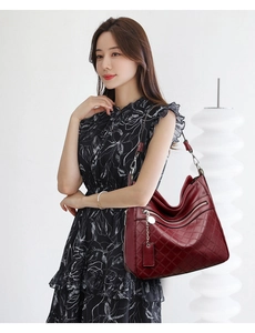 Detail of burgundy multi-layer soft leather tote bag with elegant quilted pattern