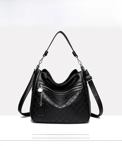 Detailed front view of black litchi pattern leather bag with silver zipper and charm