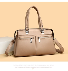 Close-up of soft lychee texture leather handbag with functional front zipper detail