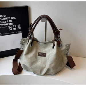 Macro detail of high-quality sage green PU leather tote bag with silver metal eyelets