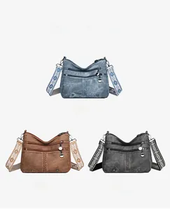 Detail view of retro PU leather crossbody bags in blue, brown, and black with patterned straps