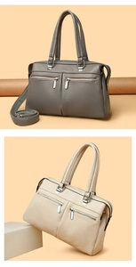 Detail of pebbled leather texture with silver zippers on grey and cream handbags