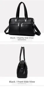 Detalle del bolso de mano negro en piel granulada con cremalleras y herrajes plata