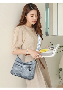 Detail of light gray multi-zipper crossbody bag with floral pattern wide shoulder strap