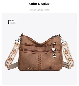 Detail of vintage brown crossbody bag featuring multi-zipper pockets and ethnic strap